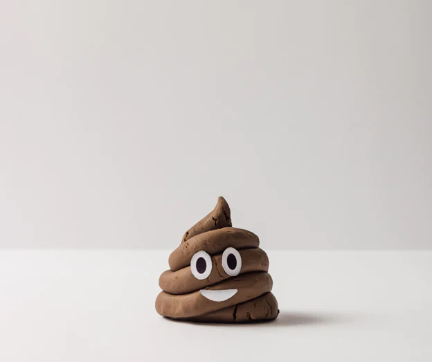 Photo of a clay sculpture of the poop emoji.