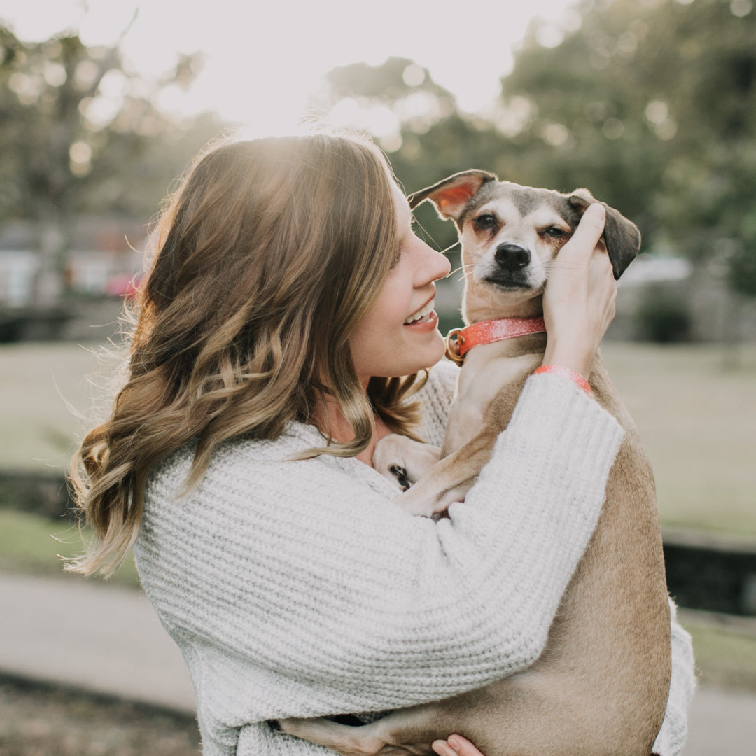 Photo of a woman hugging her dog.